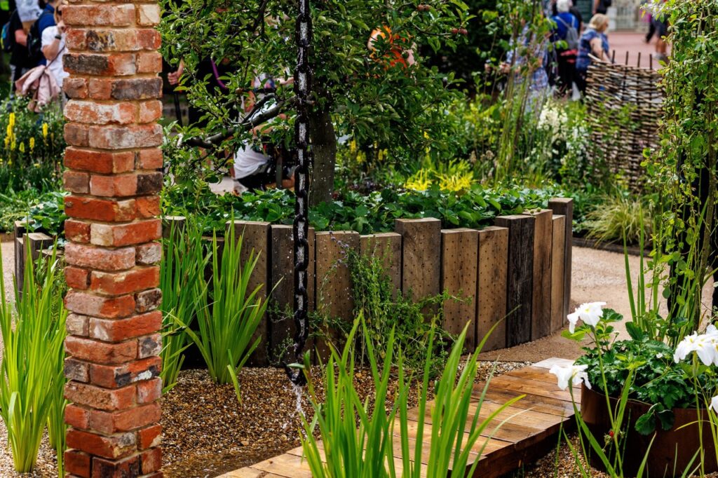 Used vertically, sleepers become a sculptural garden edge rather than simply a practical one.